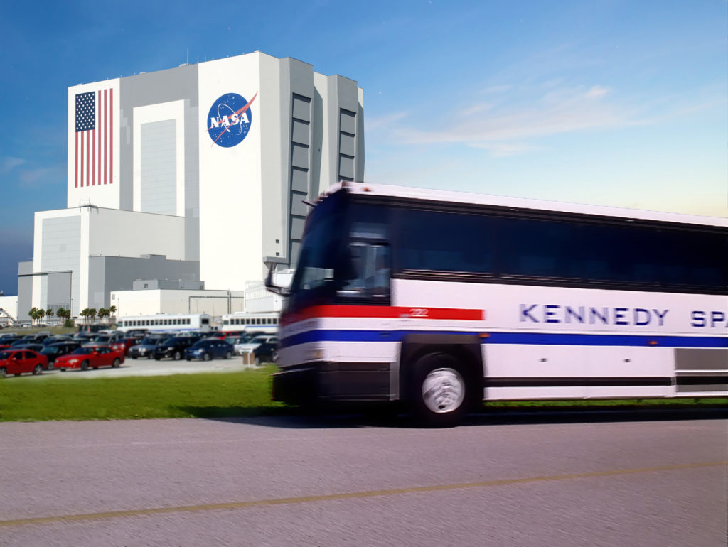 A Shuttle Bus zips by the Vehicle Assembly Building (VAB) - Kennedy Space Center Visitor Complex