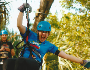 A woman starts her Zip Lining thrill at Treetop Trek, Brevard Zoo | Viera FL