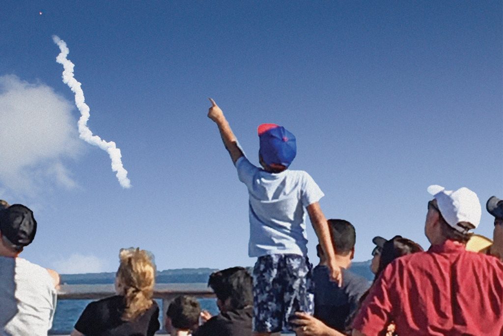 Child on Beach watching Rocket Launch into Space